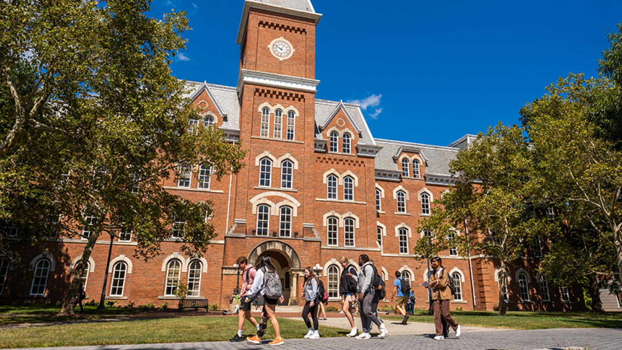 People walking on campus in front of University Hall.